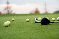 Golf balls and sticks on green golf course Royalty Free Stock Photo