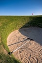 Golf bunker with rake and red flag Royalty Free Stock Photo