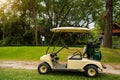 Golf cart or car club and blurred golfer swing golf ball to green in golf course Royalty Free Stock Photo