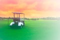 Golf cart car in fairway of golf course with fresh green grass field and cloud sky background Royalty Free Stock Photo