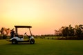 Golf cart car in fairway of golf course with fresh green grass field Royalty Free Stock Photo