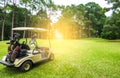 Golf cart and golfer on fairway in golf course Royalty Free Stock Photo