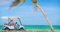 Golf cart at tropical beach