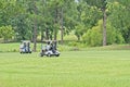Golf carts on a green golf course Royalty Free Stock Photo