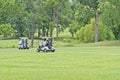 Golf carts on a green golf course Royalty Free Stock Photo