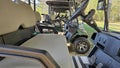 Golf carts lined up under a canopy on a clear day at the course Royalty Free Stock Photo