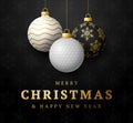 Golf Christmas card. Merry Christmas sport greeting card. Hang on a thread golf ball as a xmas ball and golden bauble on black Royalty Free Stock Photo