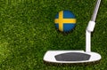 A golf club and a ball with flag Sweden during a golf game