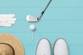 Golf club, golf ball, golf glove and tees on wooden base in blue Royalty Free Stock Photo