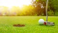 Golf club and ball in grass, Golf club and golf ball close up in grass field with sunset Royalty Free Stock Photo