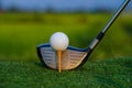 Golf club and ball on green grass ready to be struck on golf course background Royalty Free Stock Photo