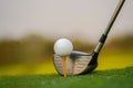 Golf club and ball on green grass ready to be struck on golf course background Royalty Free Stock Photo