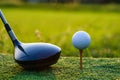 Golf club and ball on green grass ready to be struck on golf course background Royalty Free Stock Photo