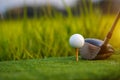 Golf club and ball on green grass ready to be struck on golf course background Royalty Free Stock Photo