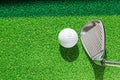 Golf club and golf ball on green grass background. Royalty Free Stock Photo