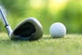 Golf club hitting golf ball along fairway towards green with copy space, green nature background. Royalty Free Stock Photo