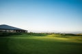 Golf club house with rays of sun at sunset Royalty Free Stock Photo