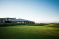 Golf club house with rays of sun at sunset Royalty Free Stock Photo