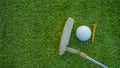 Golf clubs and golf balls on a green lawn in a beautiful golf course with morning sunshine Royalty Free Stock Photo