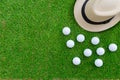 Golf concept : Panama hat, golf balls, flat lay on green glass,