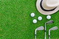 Golf concept : Panama hat, golf balls, golf iron clubs flat lay