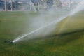 Golf course automatic lawn sprinkler Royalty Free Stock Photo