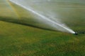 Golf course automatic lawn sprinkler Royalty Free Stock Photo