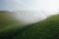 Golf course automatic lawn sprinkler Royalty Free Stock Photo