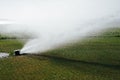 Golf course automatic lawn sprinkler Royalty Free Stock Photo