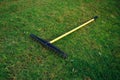 Golf course bunker rake on green grass Royalty Free Stock Photo