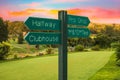 Golf course direction signs on fairway and colourful sunset Royalty Free Stock Photo