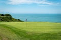 The golf course, the flag and the sea Royalty Free Stock Photo