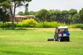 Golf course and golf cart collecting golf balls. Ballpicker on driving range of golf club Royalty Free Stock Photo