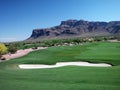 Golf Course Green Belt with Bunker and Mountains Royalty Free Stock Photo
