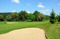 Golf course, green grass, large sand pit, trees Royalty Free Stock Photo