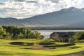 Golf course hazard and fairway with houses and lake in the background.