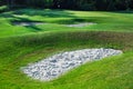 Golf course hilly terrain with Sand traps. Royalty Free Stock Photo