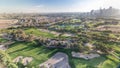 Golf course and Jumeirah lake towers skyscrapers before sunset timelapse,, Dubai, United Arab Emirates Royalty Free Stock Photo