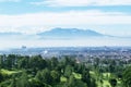 Golf course with misty Bandung cityscape background