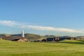 Golf course overlooking rooftops church steeple and mountain on a sunny day Royalty Free Stock Photo