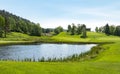 Golf course with pond, blue sky and green nature