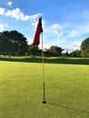 Golf course putting green hole with flag Royalty Free Stock Photo