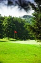 Golf course with red flag in the middle Royalty Free Stock Photo