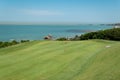 Golf course with the sea in the background Royalty Free Stock Photo