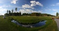 A golf course with roads, bunkers and ponds and with a river Royalty Free Stock Photo