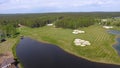 Golf course on a Sunny day, an excellent Golf club with ponds and green grass, view from the sky Royalty Free Stock Photo