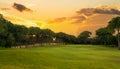 Golf course at sunset with beautiful dramatic sky. Scenic panoramic view of golf fairway. Beautiful golf field with Royalty Free Stock Photo