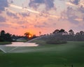 Golf course sunset with sprinklers in the sunset Royalty Free Stock Photo