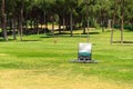 Golf course and golf cart collecting golf balls. Ballpicker on driving range of golf club Royalty Free Stock Photo