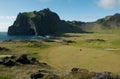 Golf course in volcanic landscape with lava, mountains and ocean Royalty Free Stock Photo